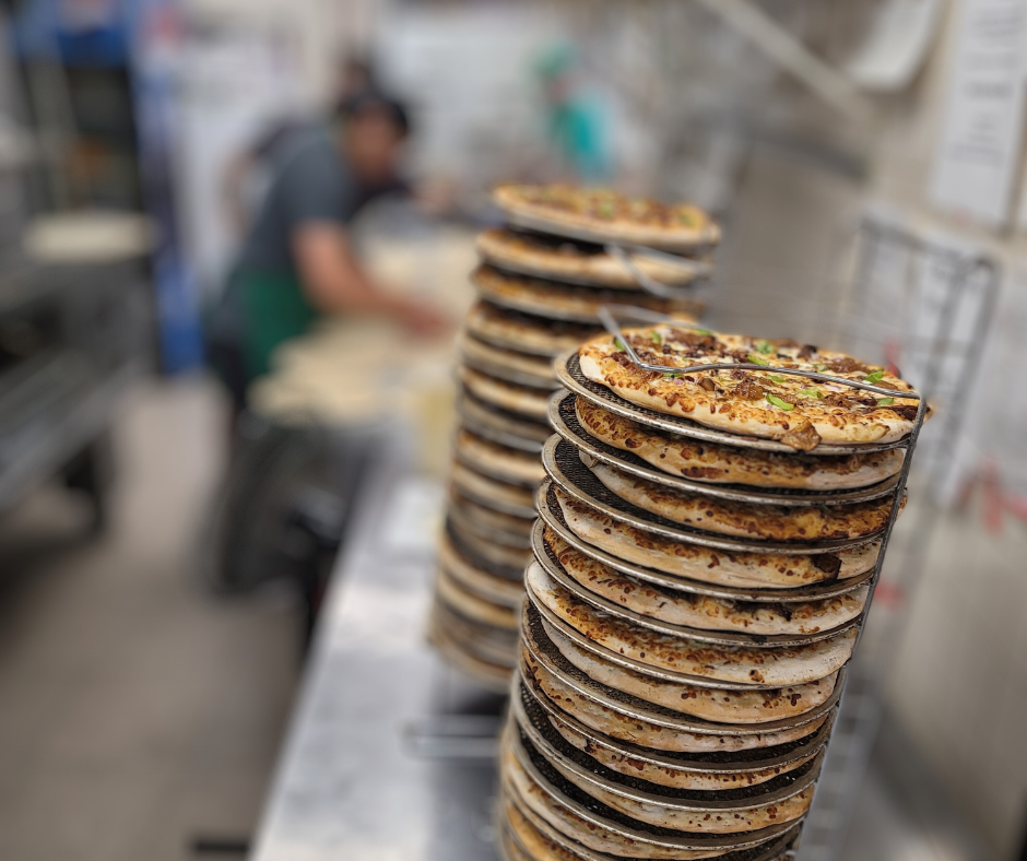 A fresh-baked Eat Local pizza ready to slice